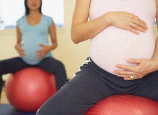 Midsection of women sitting on exercise balls